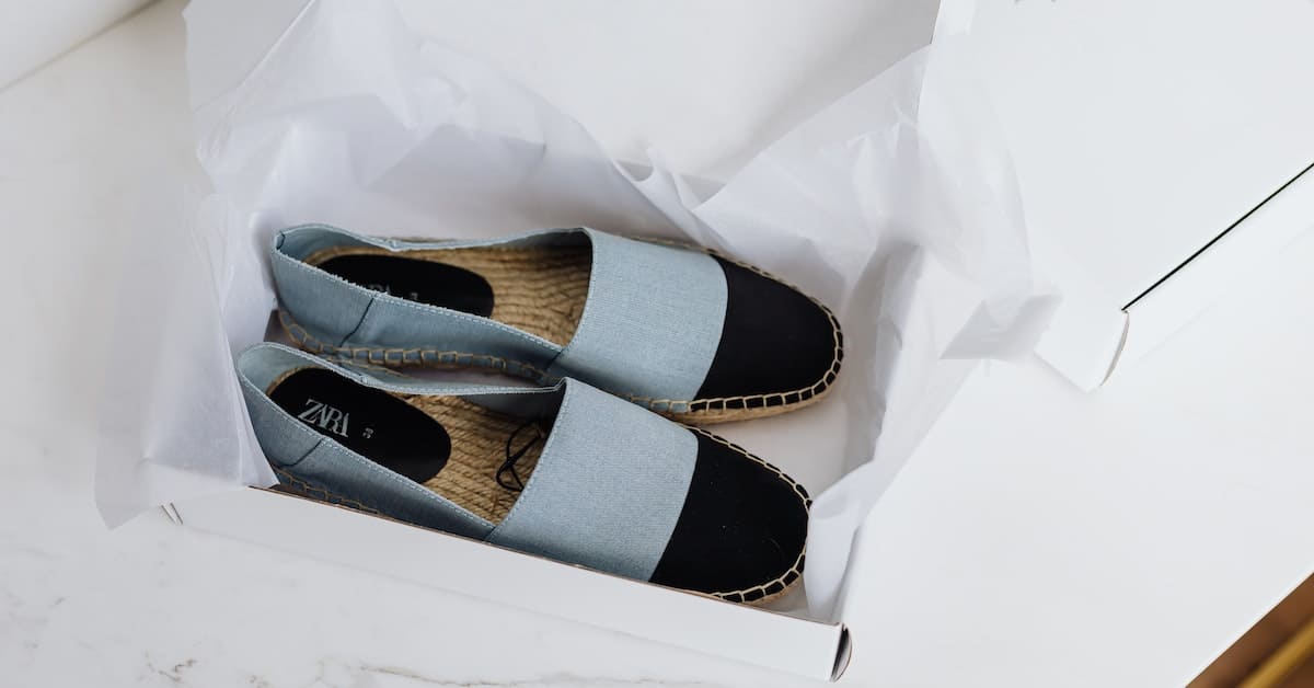 A pair of blue espadrilles resting in a box, perfect for dropshipping or a Shopify store.