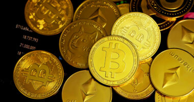 A pile of various cryptocurrency coins, including Bitcoin, Ethereum, and Dogecoin, displayed on a surface, offers an enticing glimpse into beginner strategies for investing in digital currency.